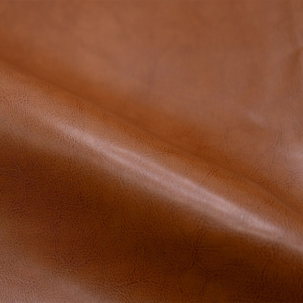 zoom matiere fauteuil club cuir camel marron